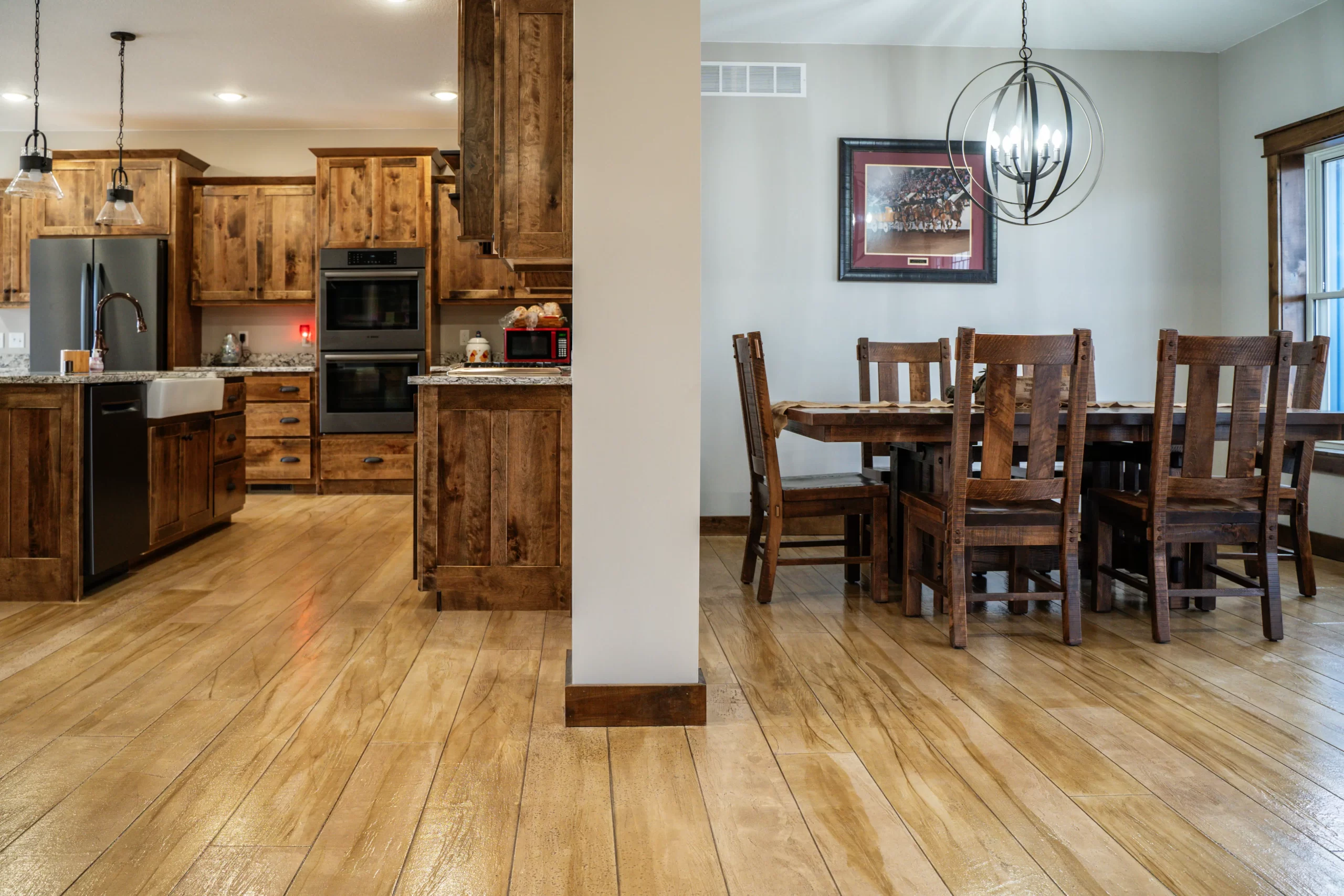 A rustic wood concrete floor in a modern kitchen.