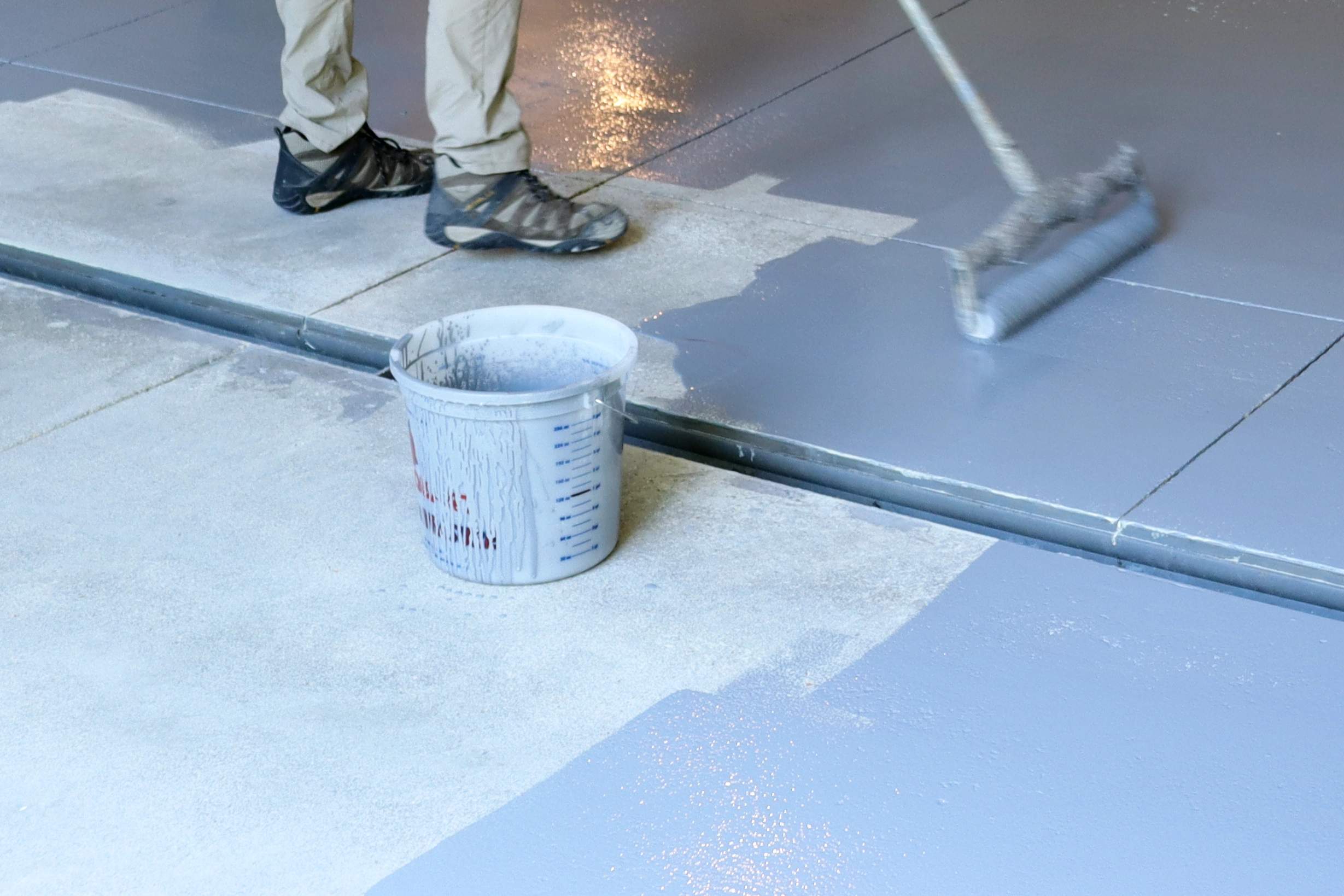 A topical vapor barrier being installed by Paveman Coatings.