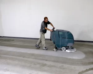 Dan cleaning a commercial concrete floor before applying a sealer.